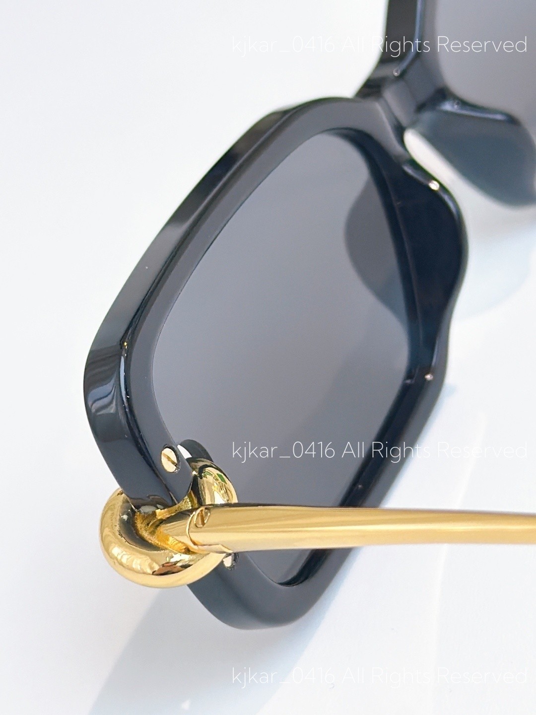 Bottega Veneta BV1439S Women’s Sunglasses Black Frame Gold Knot Gray Lenses